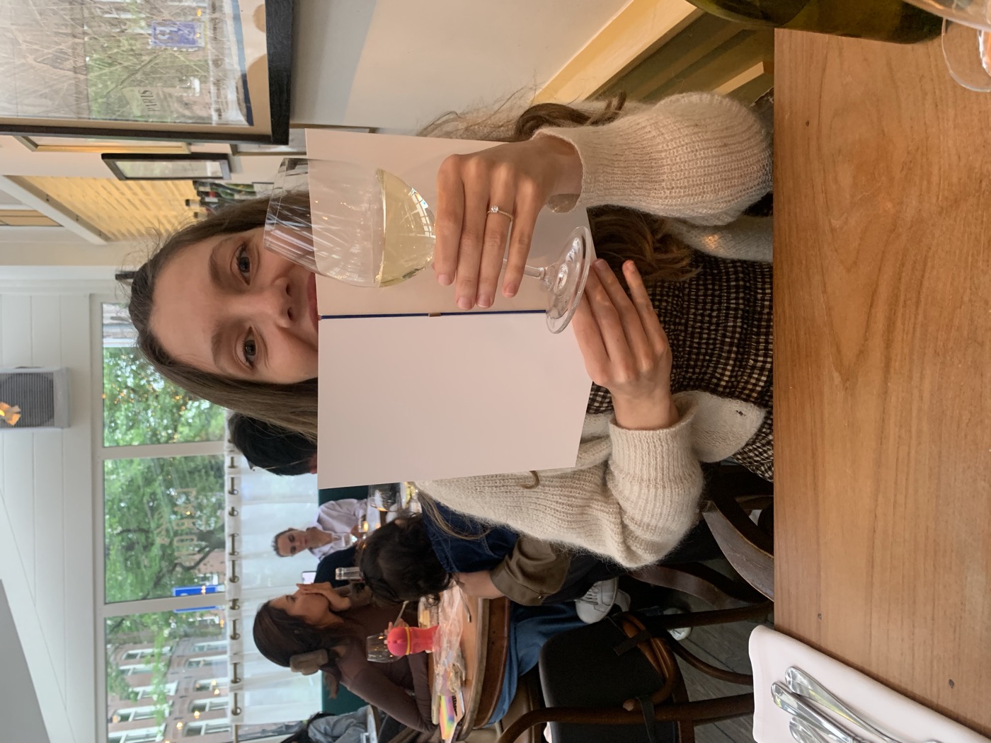 Valentine smiling with a glass of wine